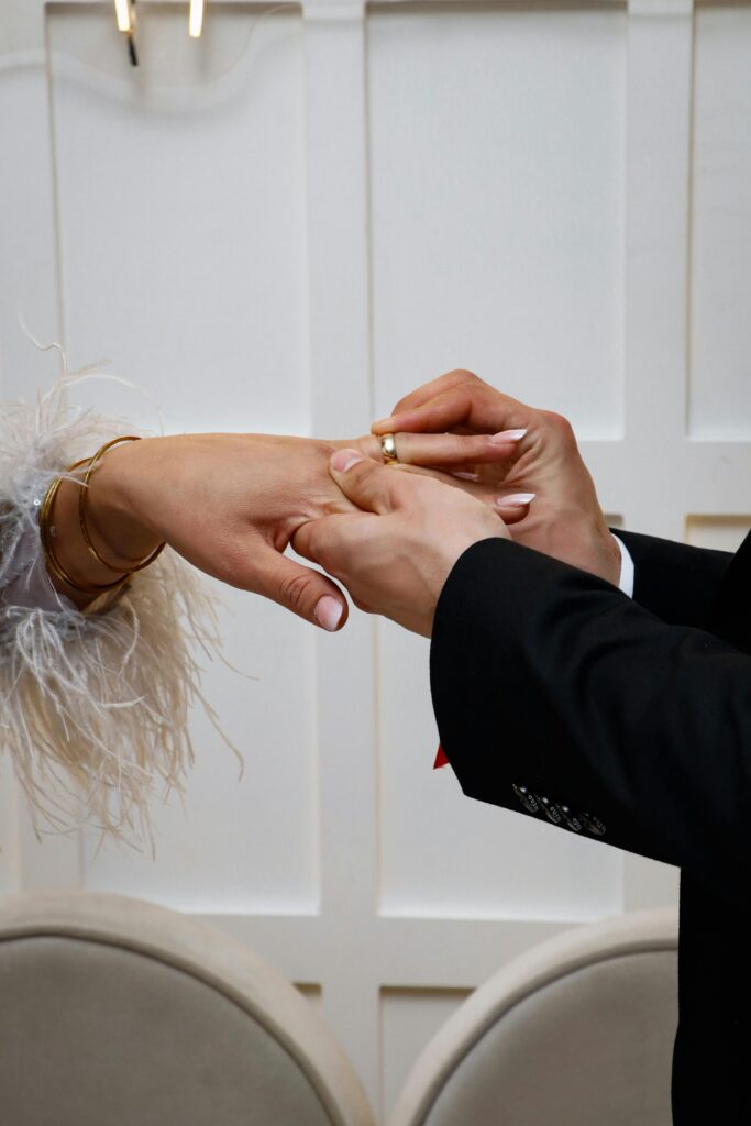 Close-up of a couple exchanging rings during a wedding ceremony.